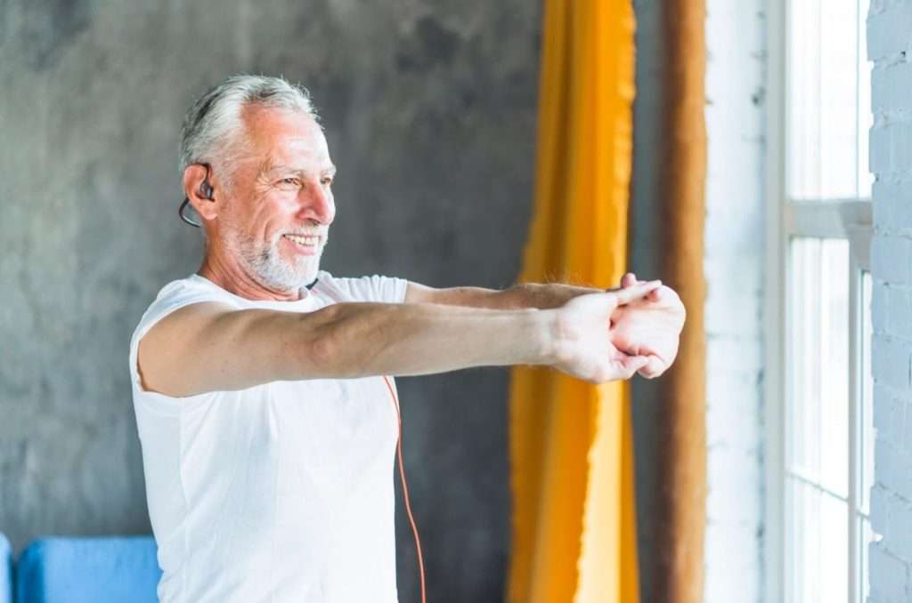 man stretching in front of the window